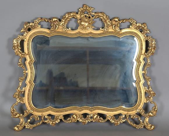 TooveysA late 20th century gilt composite wall mirror of shaped form, the f