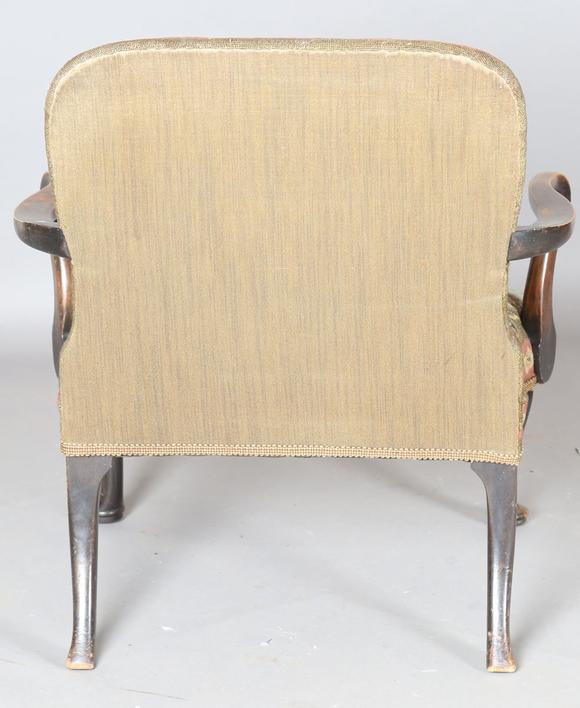 TooveysAn early 20th century walnut framed low armchair with a woolwork sea