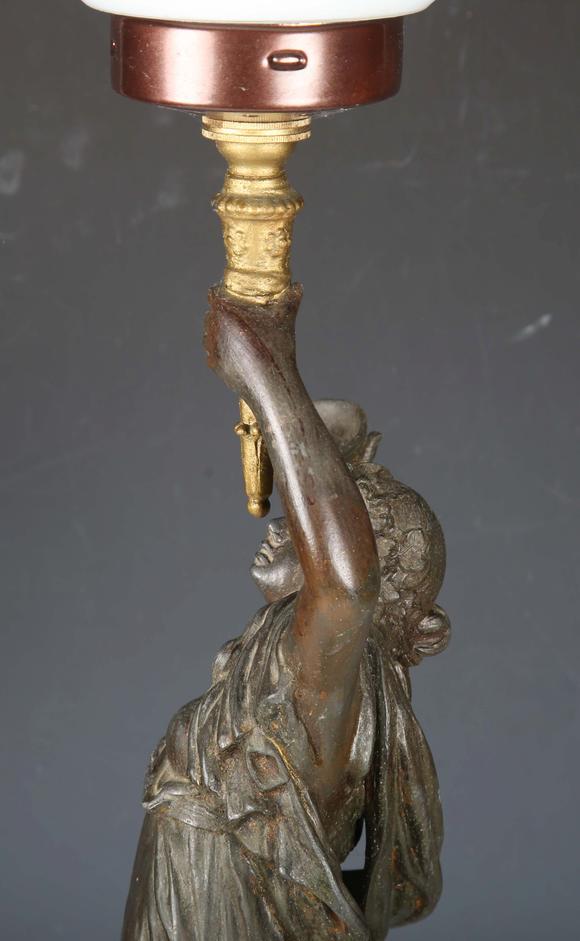 TooveysA late 19th century cast spelter figural table lamp in the form of a