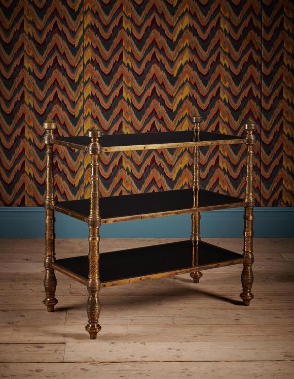 DreweattsAN UNUSUAL AESTHETIC MOVEMENT EBONISED AND ENGRAVED GILT BRASS THREE TIER ETAGERE
