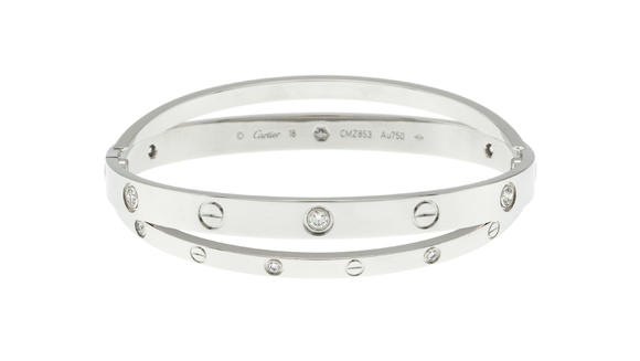 Piguet - H?tel des VentesCartier, Double Love, bracelet or gris 750 formé de deux anneaux rigides sertis de diamants taille brillant