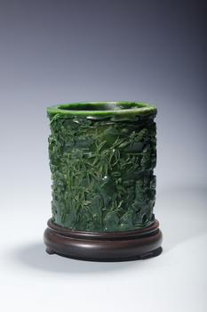 A Spinach Green Jade Cylindrical Brush Pot Carved with Mountain and Scholar Landscape, Wood Stand, China, 18th century