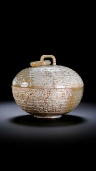 A Round White Jade Covered Box with Movable Ring Knob and Archaic Floral Scroll Carvings, 2nd BCE–3rd CE
