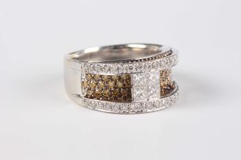 A white gold, diamond and treated yellow diamond ring in a raised design, the centre set with four principal princess cut diamonds between circular cu