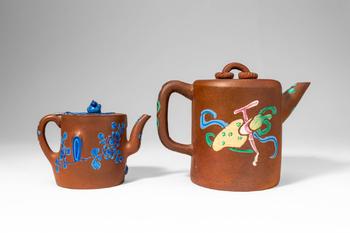 Qing Dynasty, Ca. AD 1644 - 1912. >A charming pair of Yixing stoneware teapots, each decorated wi