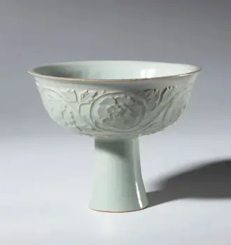 A Qingbai ceramic stemmed cup decorated with a floral motif and a celadon glaze. China, Song Dynasty (960-1269).