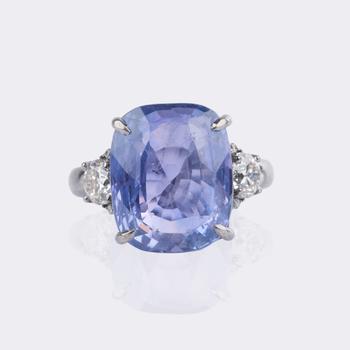 Natural color-changing Ceylon sapphire ring with diamond trim.
