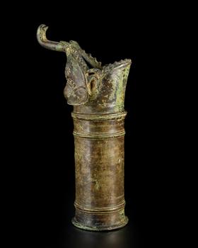 A copper alloy palanquin finial : a makara,
Possibly Karnataka, South India, 18th century or earlier,?

Ringed, its mouth wide open, its curling s