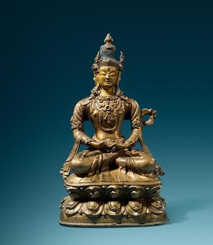 A rare Tibetan brass figure of Sarvavid Vairocana. Partially cold-gild and polychrome. 16/17th century