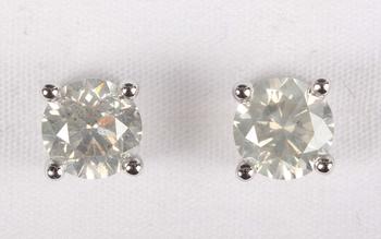 A pair of platinum and diamond single stone earstuds, each claw set