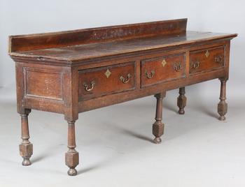 An 18th century provincial oak dresser base, fitted with three drawe