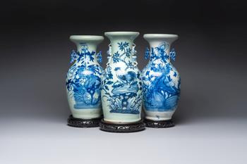 Two Chinese blue and white celadon-ground vases and a blue and white vase, on wooden stands, 19th C.