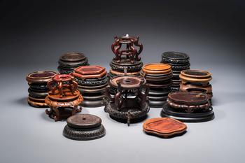 A collection of 40 mainly Chinese wooden stands, 19/20th C.