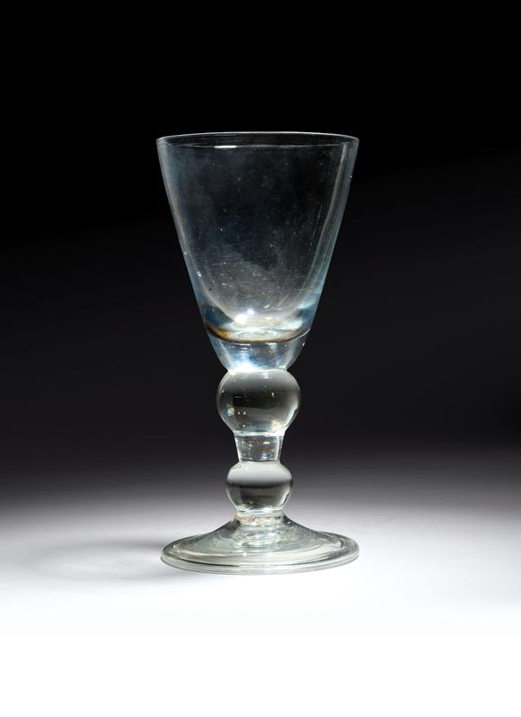 A heavy baluster goblet c.1710, the generous round funnel bowl raised
